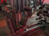 a gym with a lot of machines in the middle of the room