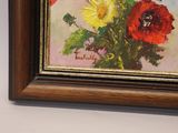 a painting of flowers in a vase on the wall