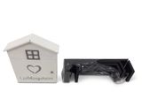a black and white picture of a small house and a black and white picture of a dog