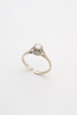 a close up of a diamond ring on a white surface