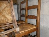 deux chaises en bois assises l'une à côté de l'autre dans une pièce