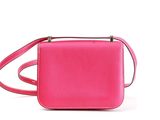 a pink cross body bag on a white background