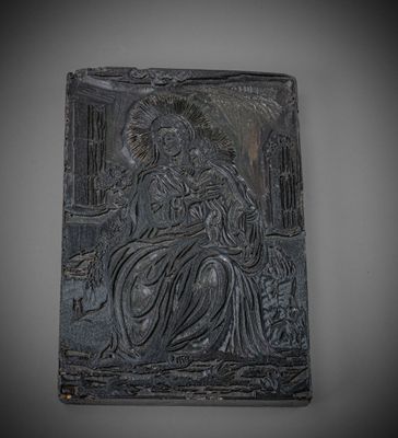 an image of a black plaque with a woman sitting on a bench