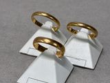 three gold rings sitting on top of a pyramid