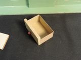 a small box that is sitting on the floor next to a book