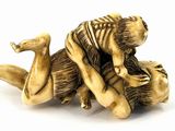 an image of a figurine of a man wrestling a tiger