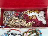 a red box filled with assorted beads and beads