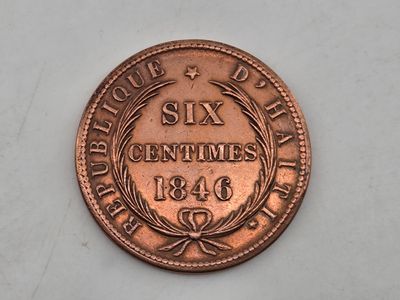 a close up of a coin on a white surface