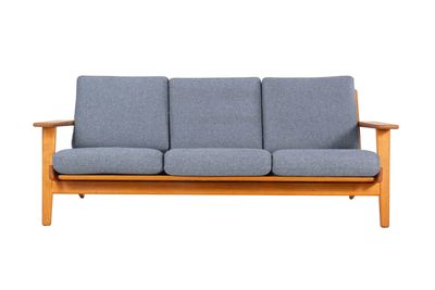 an image of a blue couch sitting on top of a wooden frame