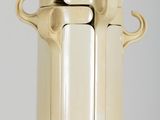 a cream colored vase with two handles on a table