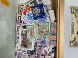 a box full of stamps and stamps on a table