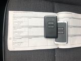 two remote controls sitting on top of a car seat
