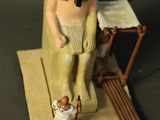 figurine of a man with a pipe in his mouth and a dog in front of him