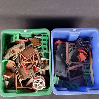 two plastic containers filled with assorted toys on a table