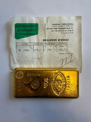 a gold bar sitting on top of a piece of paper