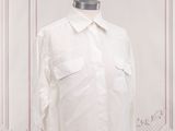 shirt on a mannequin stand in a white room