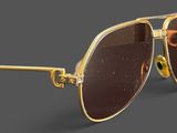 sunglasses with gold frames and brown lenses on a gray background