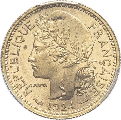 a close up of a gold coin with a woman ' s face