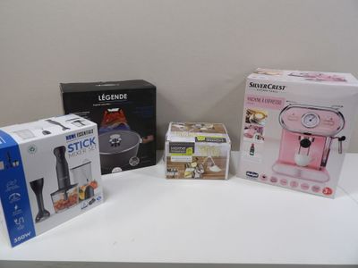 three boxes on a table with a coffee maker and a blender