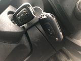 two car keys that are sitting on the dashboard of a car
