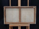 painting on easel with canvas and wooden frame on black background