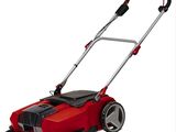 a red lawn mower sitting on top of a white surface