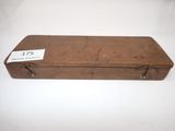 an old suitcase with a tag on it sitting on a table