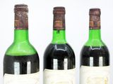 three bottles of wine sitting next to each other on a table