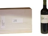a bottle of wine next to a bag of cheese