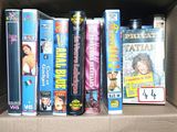 a cardboard box with a bunch of dvds in it