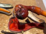 a pipe and a pipe holder sitting on a table
