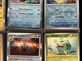 several pokemon cards sitting on top of each other on a table