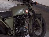 a motorcycle that is parked in a garage next to a wall