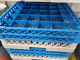 a stack of blue plastic wine glasses in a blue crate