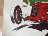 a poster of a race car on display on a table