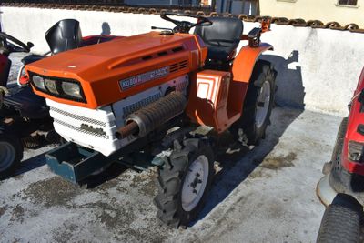 an orange tractor parked next to a red truck