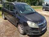 a small black car parked on the side of the road