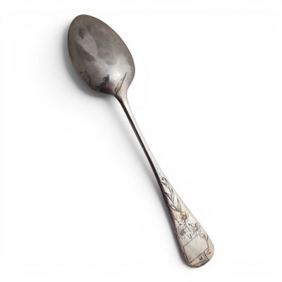 a spoon that is sitting on a white surface