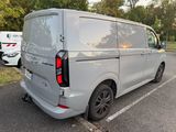 a silver van that is parked in a parking lot