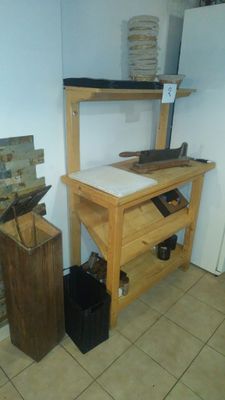 a wooden workbench in the corner of a kitchen