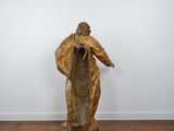 an image of a statue of a man standing on top of a wooden floor