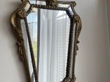 a mirror hanging on the wall next to a window