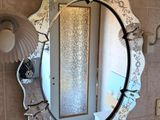 a mirror that is hanging on the wall in the bathroom