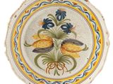a decorative plate with flowers on it on a white background