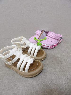 two pairs of shoes on the floor next to each other