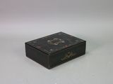 a black box with a clock on it on a white surface