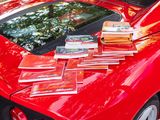 a red sports car with books on top of it