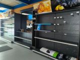 many empty shelves in a store that are full of items