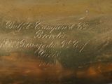 a close up of a brass plate with writing on it