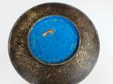 a picture of a blue and gold bowl with a fish in it